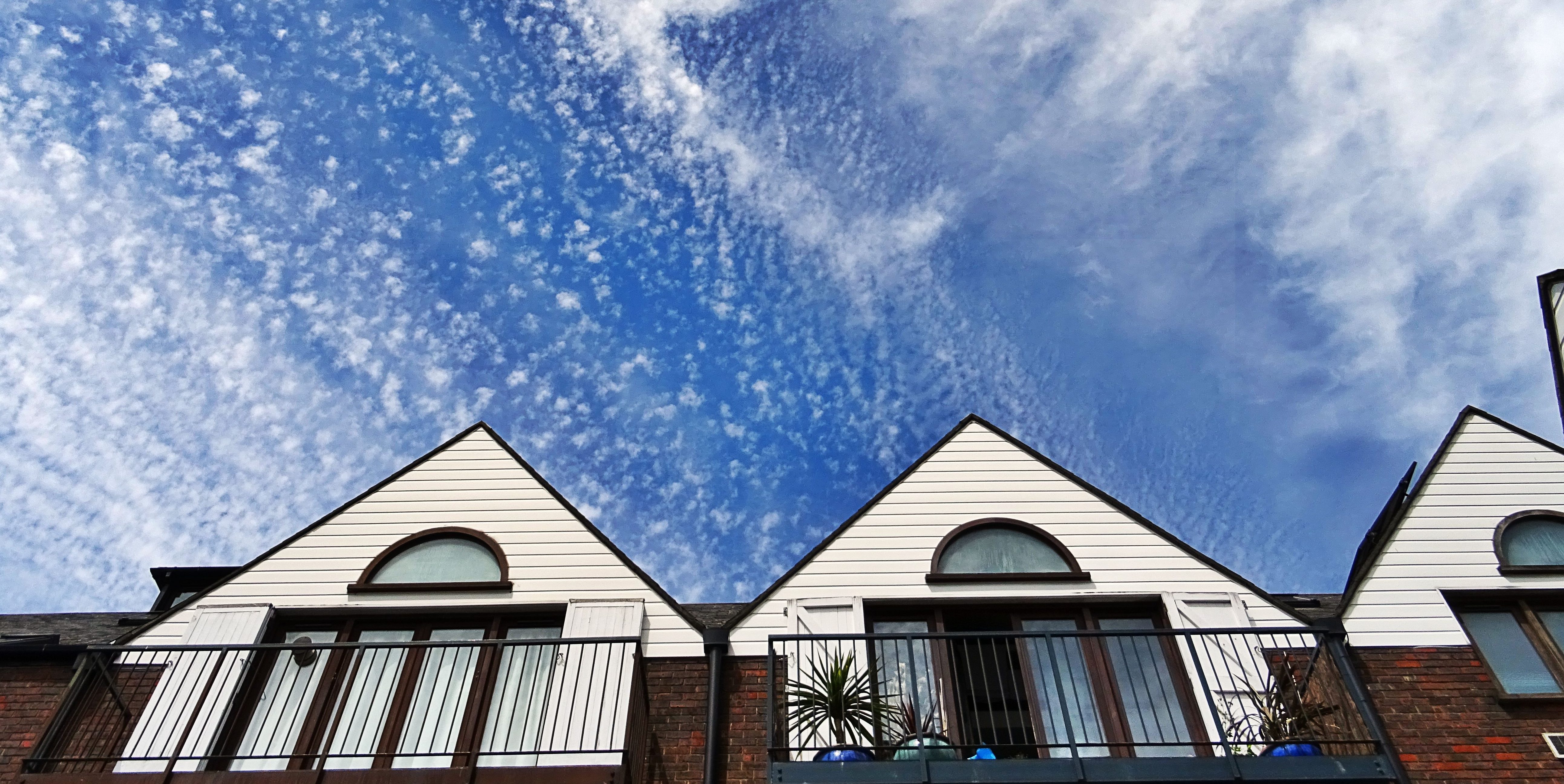 apartments-balcony-clouds-439404