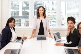 woman-standing-on-the-center-table-with-four-people-on-the-1367271