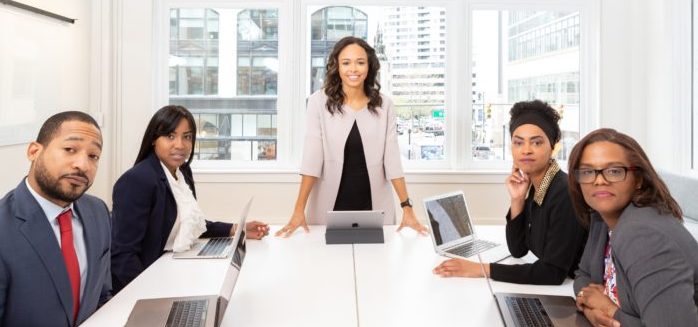 woman-standing-on-the-center-table-with-four-people-on-the-1367271