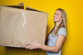 woman-in-grey-shirt-holding-brown-cardboard-box-761999