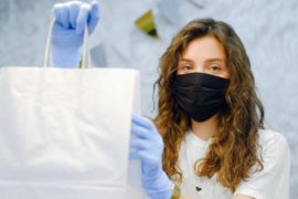 woman-with-face-mask-and-latex-gloves-holding-a-shopping-bag-4226269