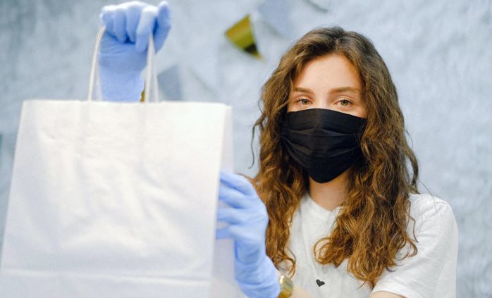 woman-with-face-mask-and-latex-gloves-holding-a-shopping-bag-4226269